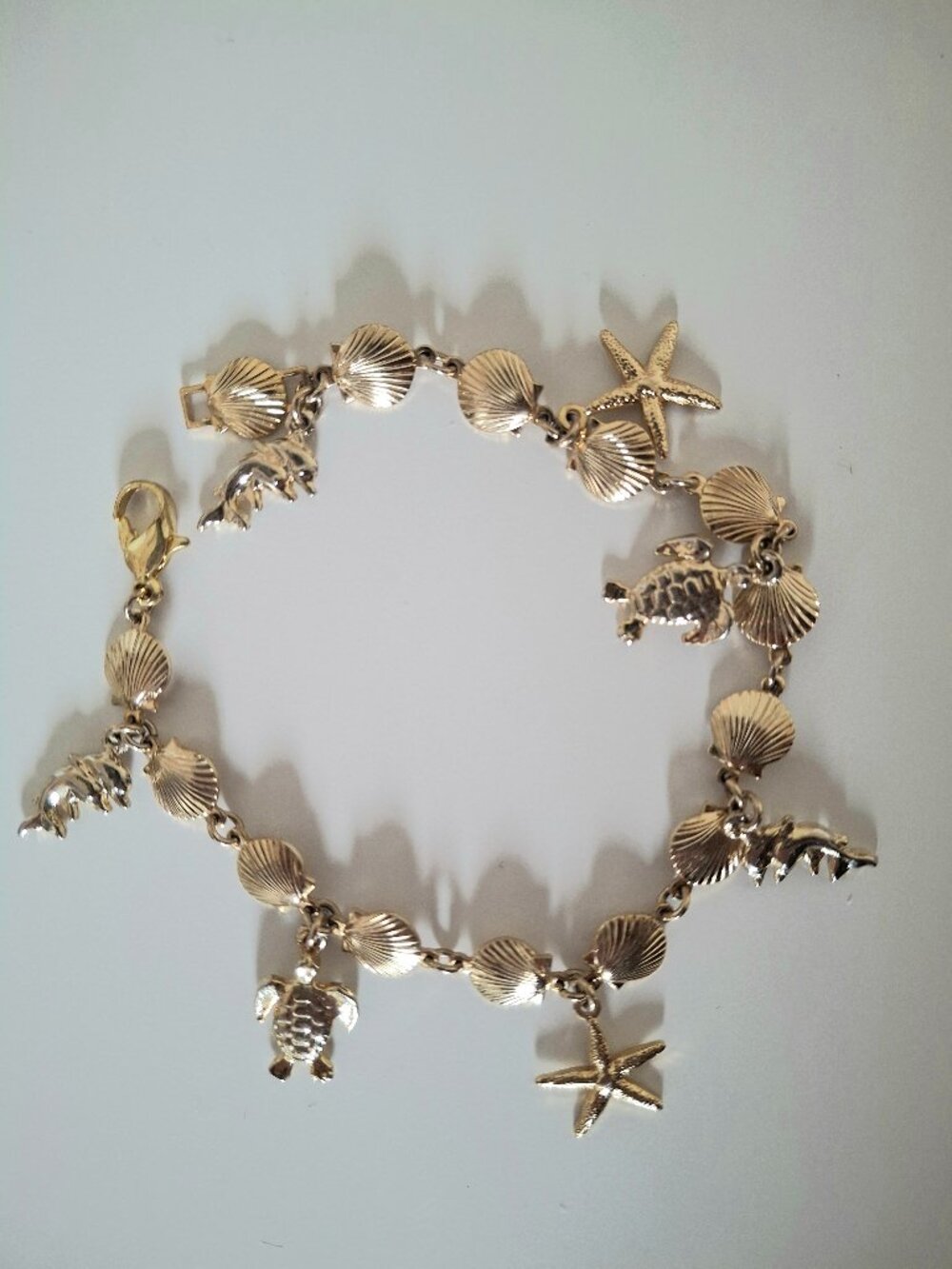 Goldtone beach bracelet- shells, starfish, turtle, dolphin